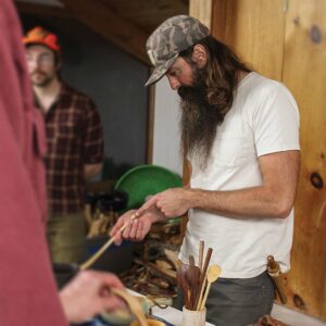 Dawson Moore in his workshop with his handcrafted wood spoons.
