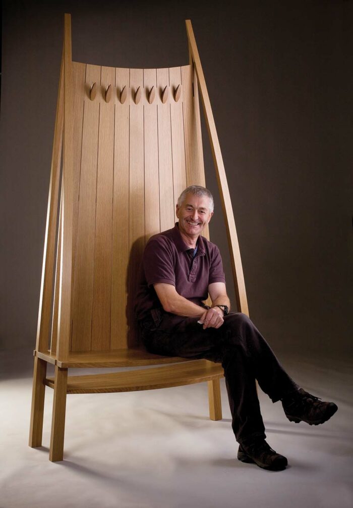 Aled Lewis with his settle wood chair
