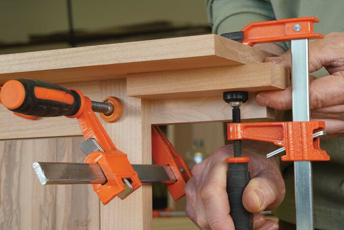 Blowout block. Clamp on a backer block to prevent chipout where the bit will exit the edge of the door.